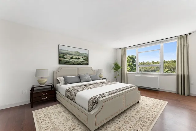 a bedroom with a large bed and a window