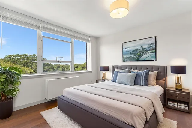 a bedroom with bed and a window