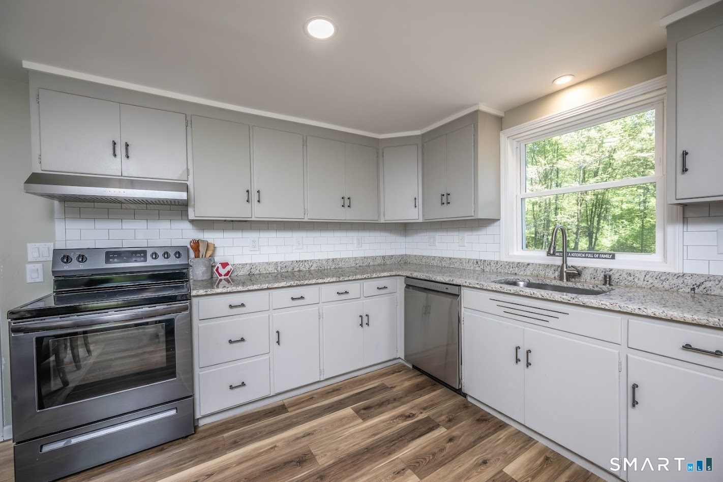 394 Brainard Hill Road Haddam, CT 06441 - Photo 8 of 23 a kitchen with granite countertop white cabinets and appliances
