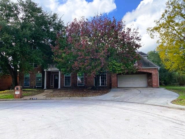 5710 Desert Oak Way Spring, TX 77379 - Photo 2 of 30 a front view of a house with a yard and trees