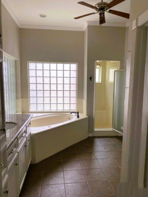 5710 Desert Oak Way Spring, TX 77379 - Photo 26 of 30 a bathroom with a bathtub and a shower