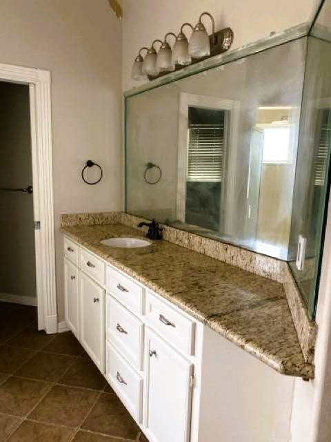 5710 Desert Oak Way Spring, TX 77379 - Photo 27 of 30 a bathroom with a granite countertop sink and a mirror