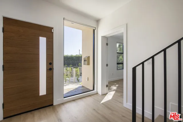 a view of an entryway with wooden floor and door
