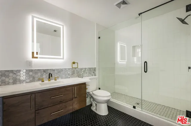 a bathroom with a toilet sink and shower