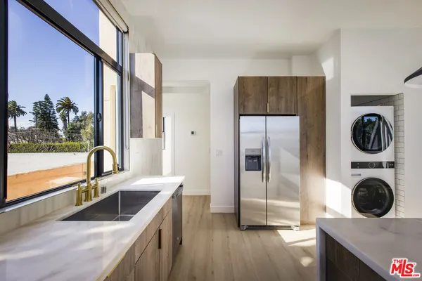 a kitchen with a refrigerator and a sink