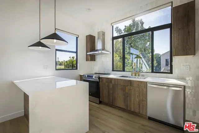 a kitchen with a sink stove and cabinets