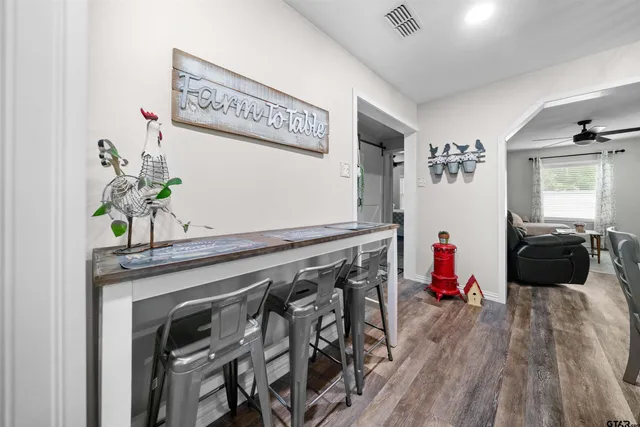 a kitchen with a wooden floor and a refrigerator