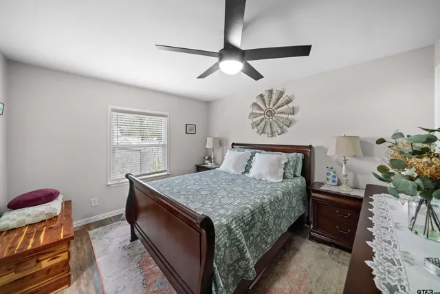 a bedroom with a large bed and a chandelier