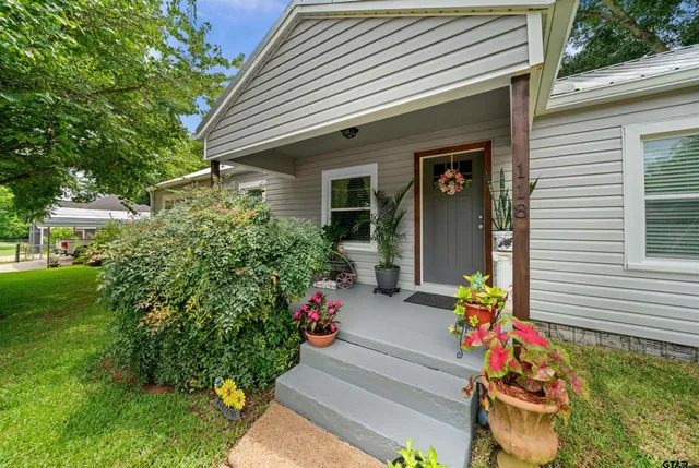 a front view of a house with outdoor seating