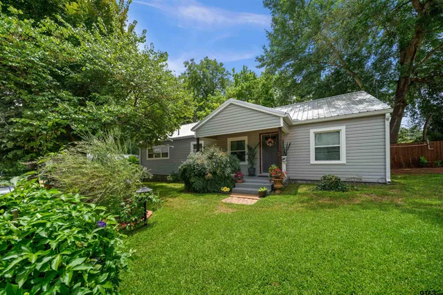 a view of a house with a yard and sitting area