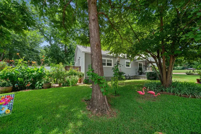 a front view of a house with fountain and garden