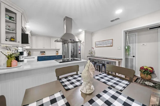 a kitchen with a table and chairs