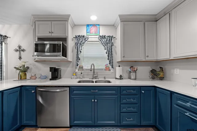 a kitchen with stainless steel appliances granite countertop a sink stove and microwave