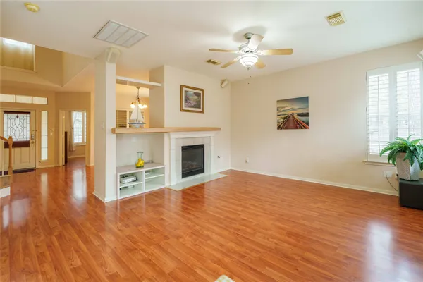 a view of empty room with wooden floor and fireplace