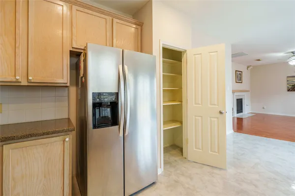 a view of a kitchen with refrigerator and cabinet