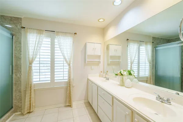 a bathroom with a glass shower door