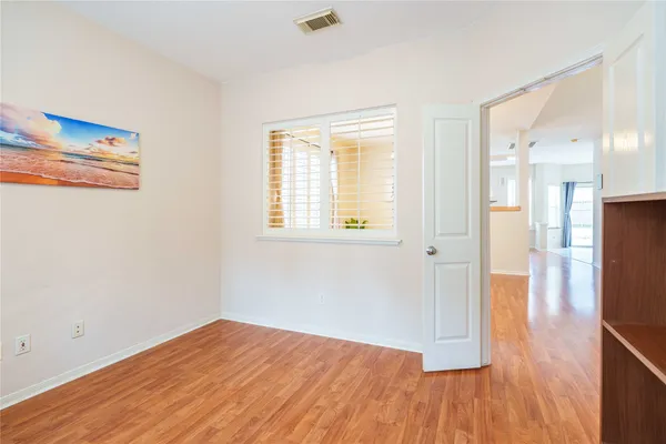 a view of a room with wooden floor and a flat screen tv