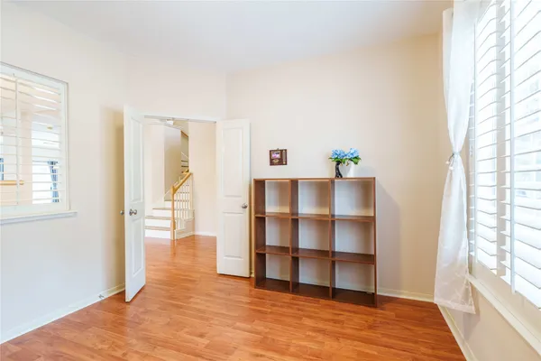 a view of a livingroom with wooden floor and windows