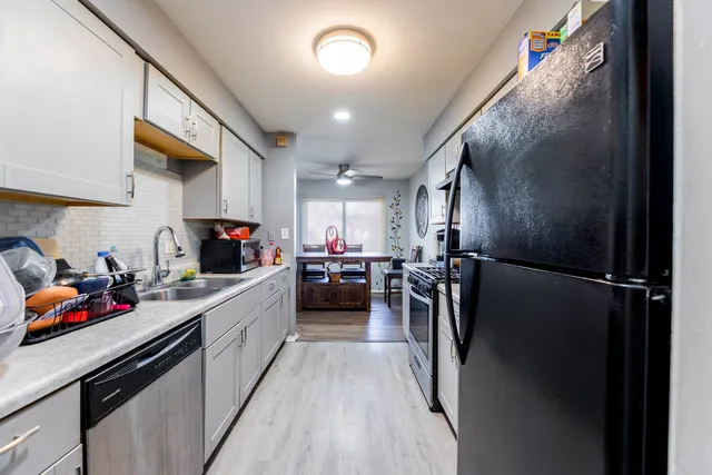 a kitchen with a sink and refrigerator