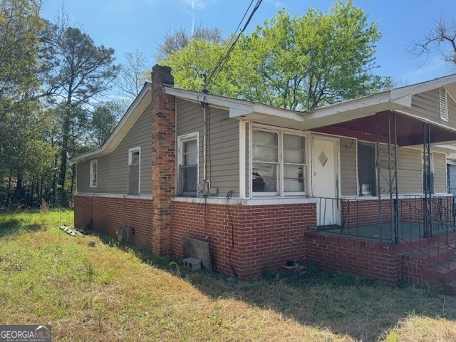 107 Benjamin Street Fort Valley, GA 31030 - Photo 22 of 26 a view of house with a yard and wooden fence