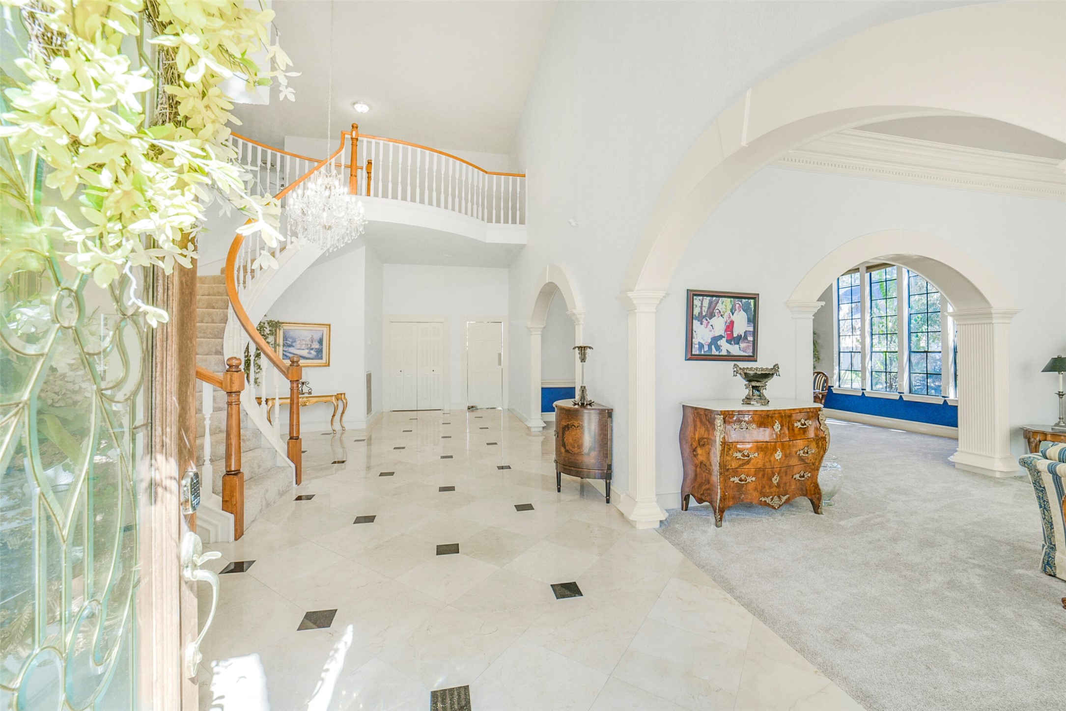 17302 Atherington Place Spring, TX 77379 - Photo 5 of 50 Dramatic marble entry with granite inlays welcomes you in, highlighted by a sweeping spiral staircase and elegant architectural detail.