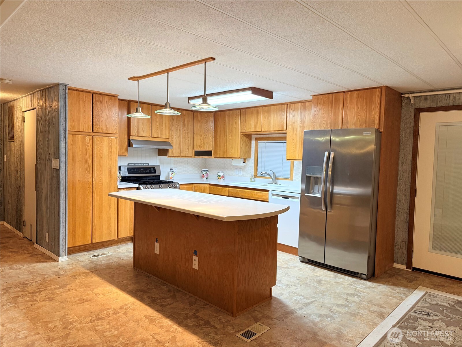 411 Southwest College Avenue Wilbur, WA 99185 - Photo 3 of 40 a kitchen with stainless steel appliances granite countertop a refrigerator a sink and a stove