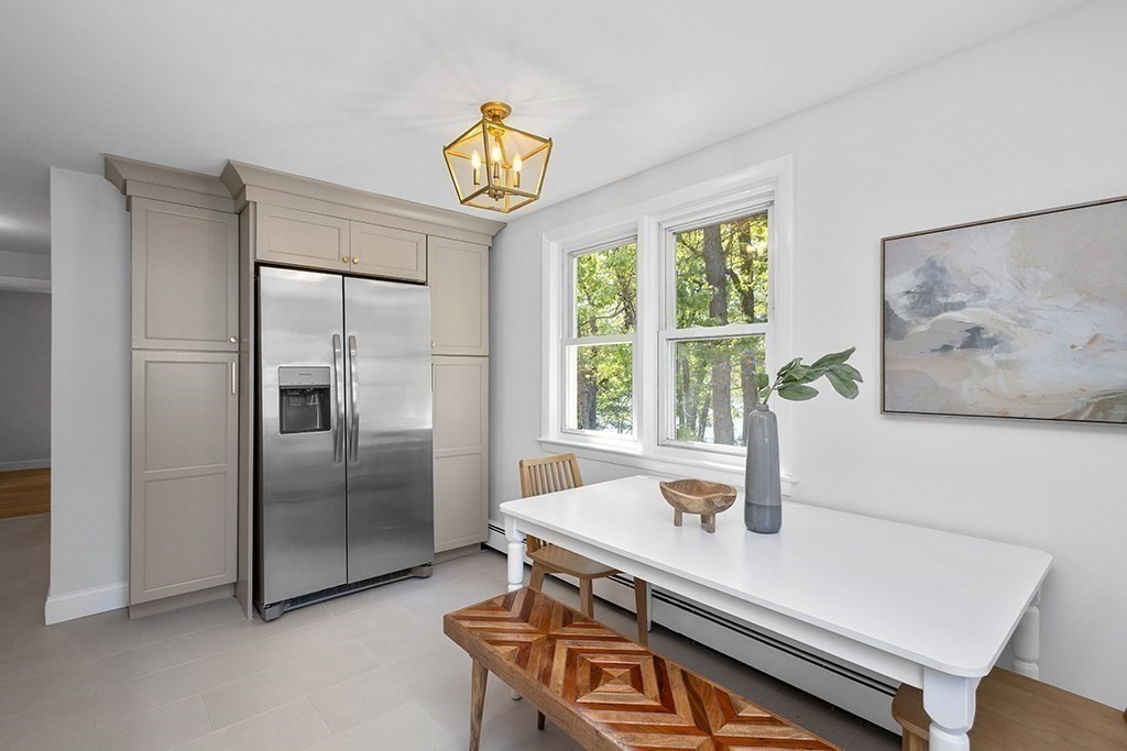 117 Oak Ridge Drive Ayer, MA 01432 - Photo 9 of 26 a kitchen with stainless steel appliances a refrigerator and a window