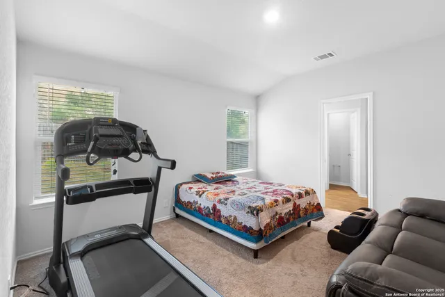 a bedroom with a bed and a couch