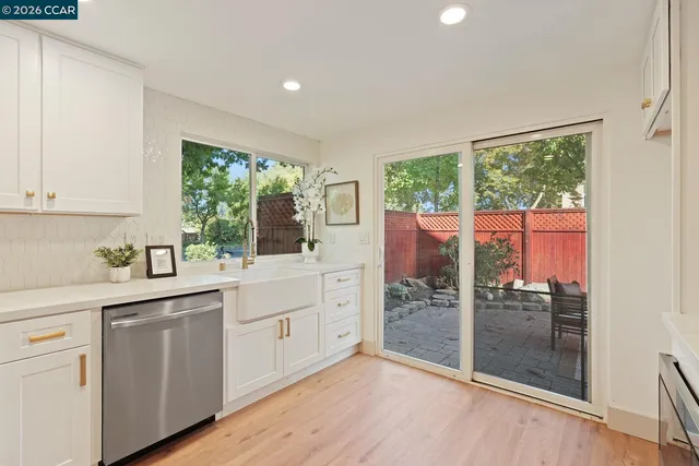a kitchen with a window a sink appliances and cabinets