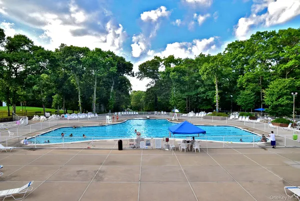 a view of backyard with swimming pool and outdoor seating