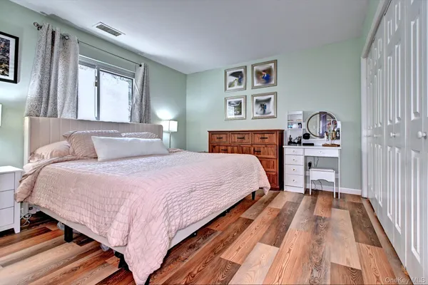 a bedroom with a large bed and a window