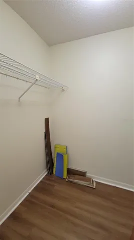 a view of a room with wooden floor and bench