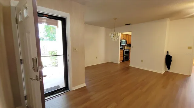 a view of empty room with wooden floor