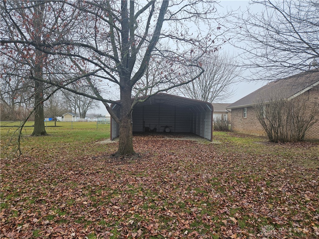 4909 Shannon Avenue Springfield, OH 45504 - Photo 20 of 21 This spacious yard offers ample outdoor living potential, featuring a detached carport and mature trees.