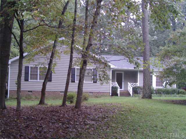 3833 Whispering Branch Road Raleigh, NC 27613 - Photo 1 of 12 a front view of a house with garden