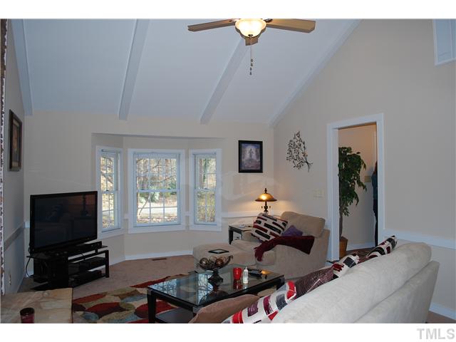3833 Whispering Branch Road Raleigh, NC 27613 - Photo 4 of 12 a living room with furniture a flat screen tv and a window