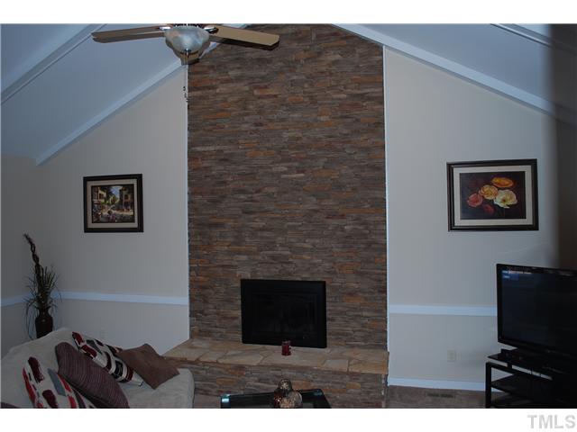 3833 Whispering Branch Road Raleigh, NC 27613 - Photo 5 of 12 a view of a livingroom with furniture and a flat screen tv
