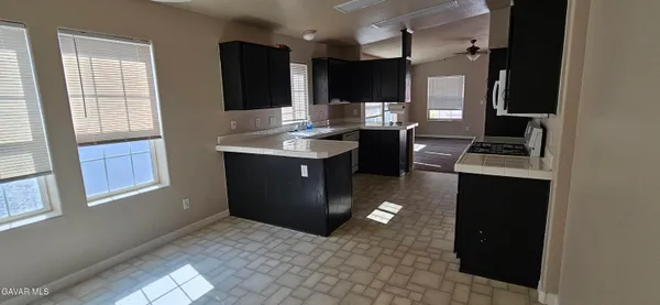 a kitchen with a sink cabinets and window