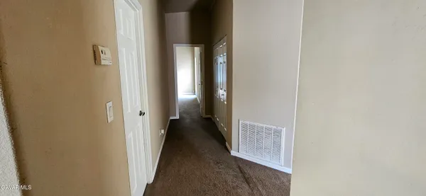 a view of a hallway with a wooden floor