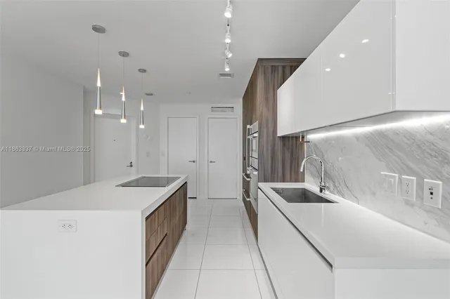 a kitchen with a sink and a refrigerator