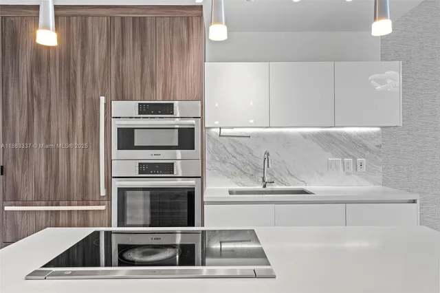 a kitchen with a sink stove and refrigerator