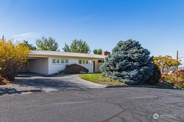 a view of house with outdoor space and garden