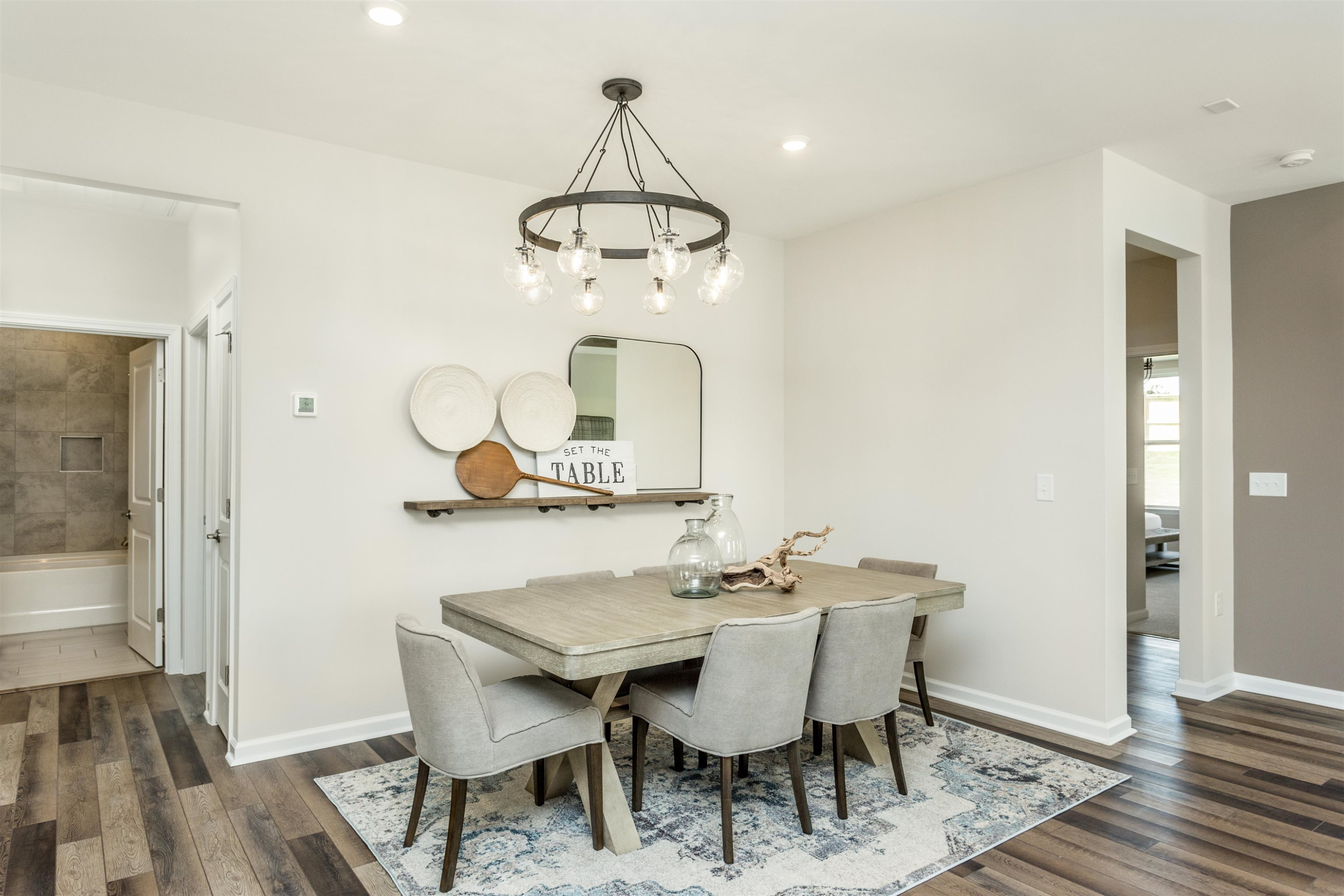 1405 Hornbeam Road Fuquay-Varina, NC 27526 - Photo 12 of 25 a dining room with wooden floor a chandelier a wooden table and chairs