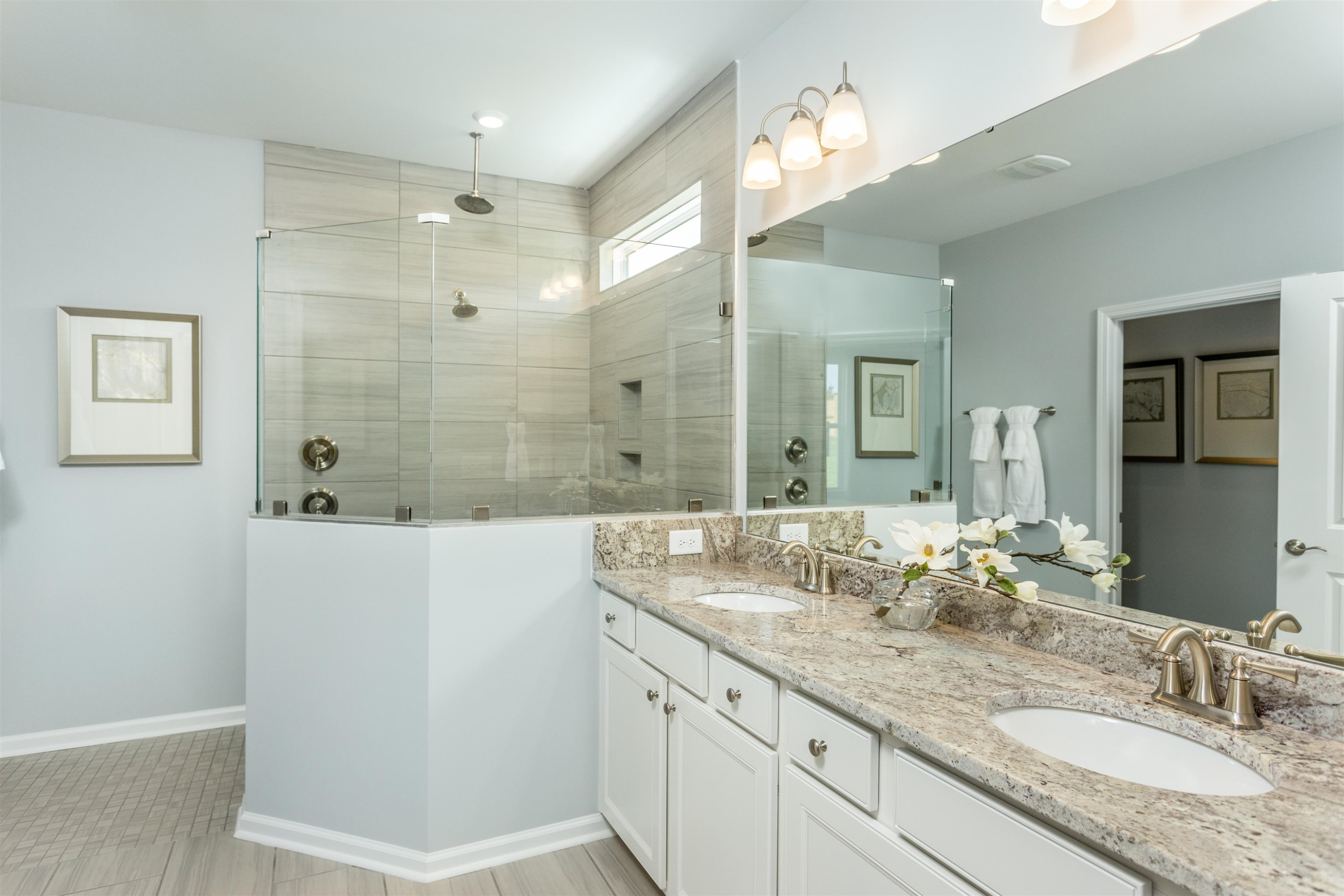 1405 Hornbeam Road Fuquay-Varina, NC 27526 - Photo 19 of 25 a bathroom with a granite countertop sink a mirror and a shower