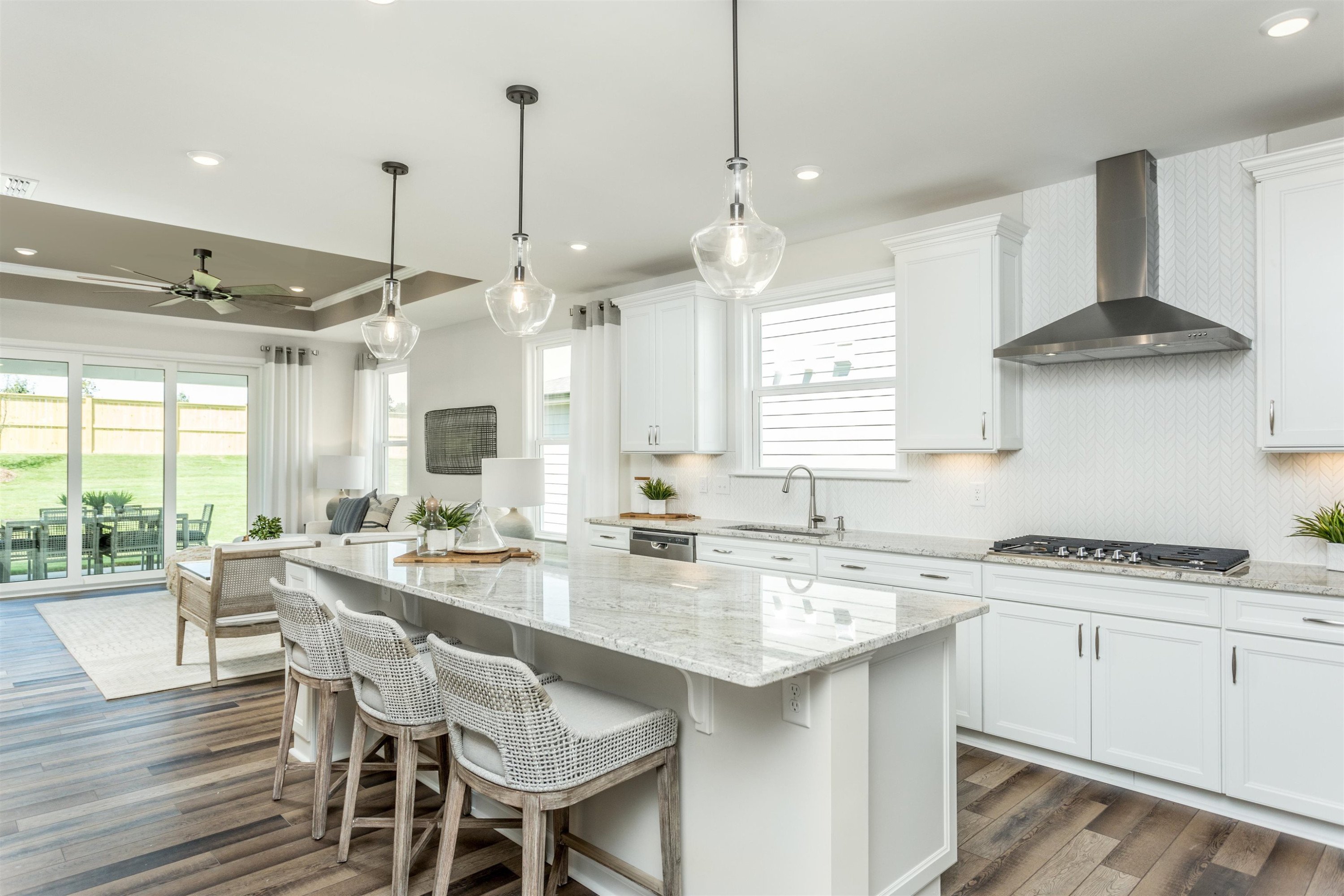 1405 Hornbeam Road Fuquay-Varina, NC 27526 - Photo 8 of 25 a kitchen with stainless steel appliances a stove a sink a center island and a wooden floor