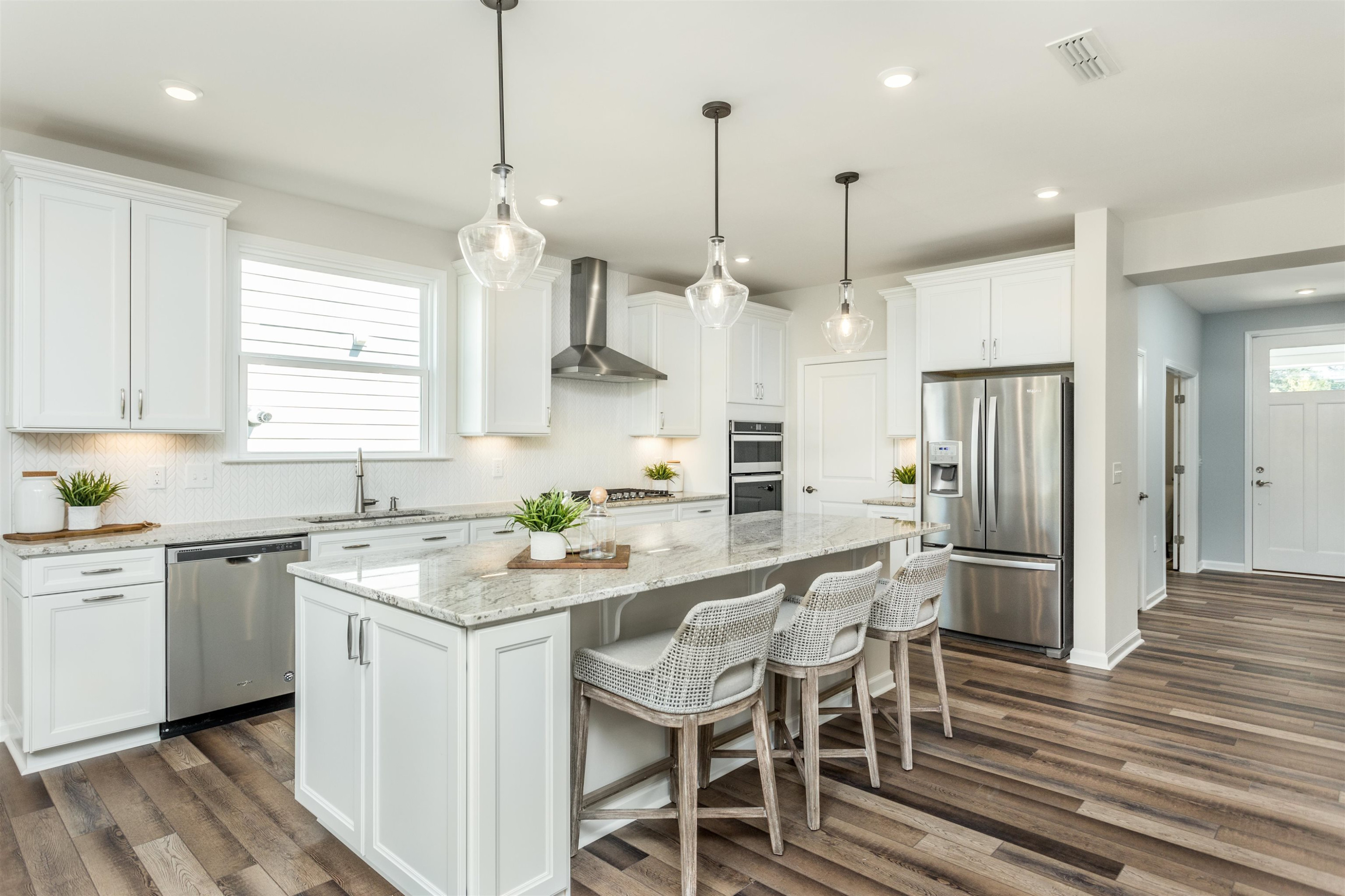 1405 Hornbeam Road Fuquay-Varina, NC 27526 - Photo 9 of 25 a kitchen with stainless steel appliances granite countertop a kitchen island hardwood floor sink and stove