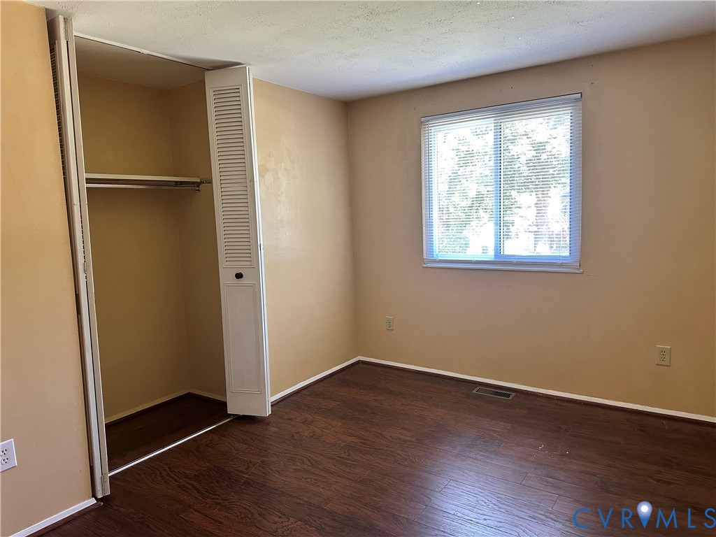 9319 Coleson Road Glen Allen, VA 23060 - Photo 12 of 39 an empty room with wooden floor closet and windows