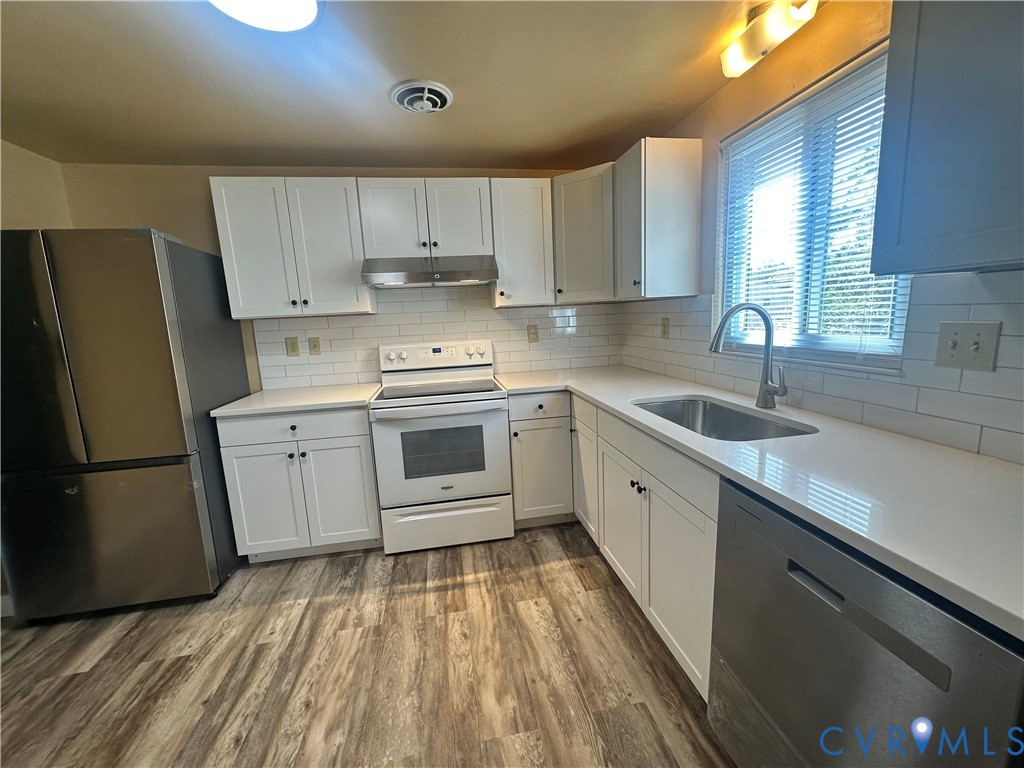 9319 Coleson Road Glen Allen, VA 23060 - Photo 16 of 39 a kitchen with a sink a refrigerator and cabinets