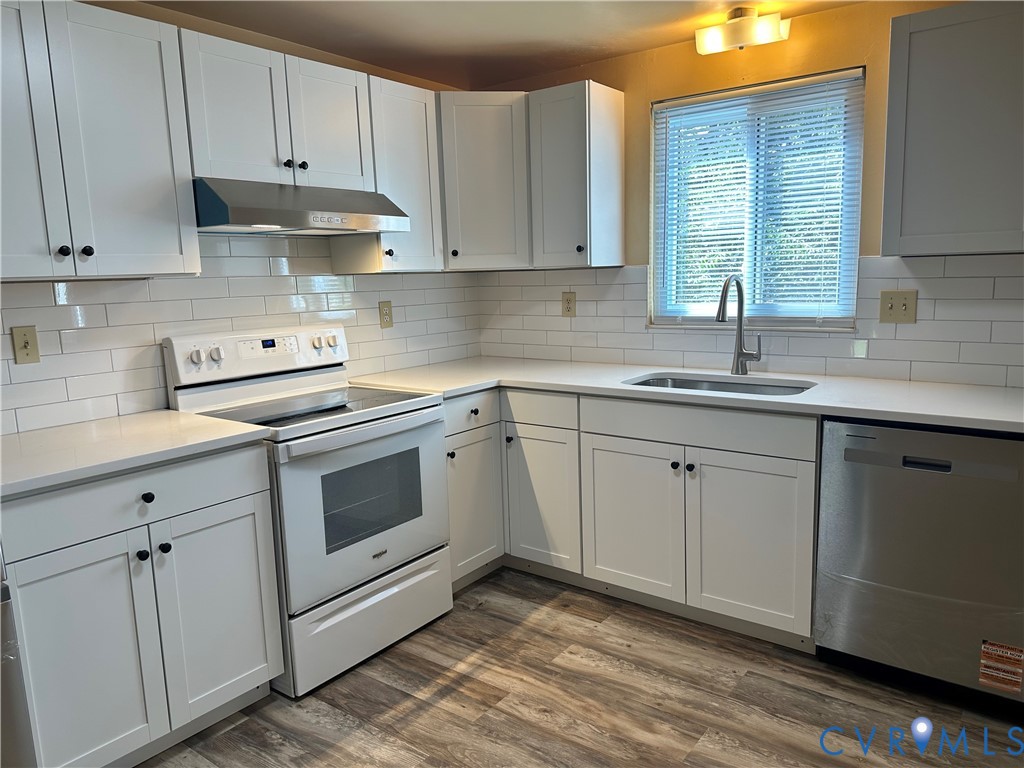 9319 Coleson Road Glen Allen, VA 23060 - Photo 17 of 39 a kitchen with white cabinets appliances a sink and a window