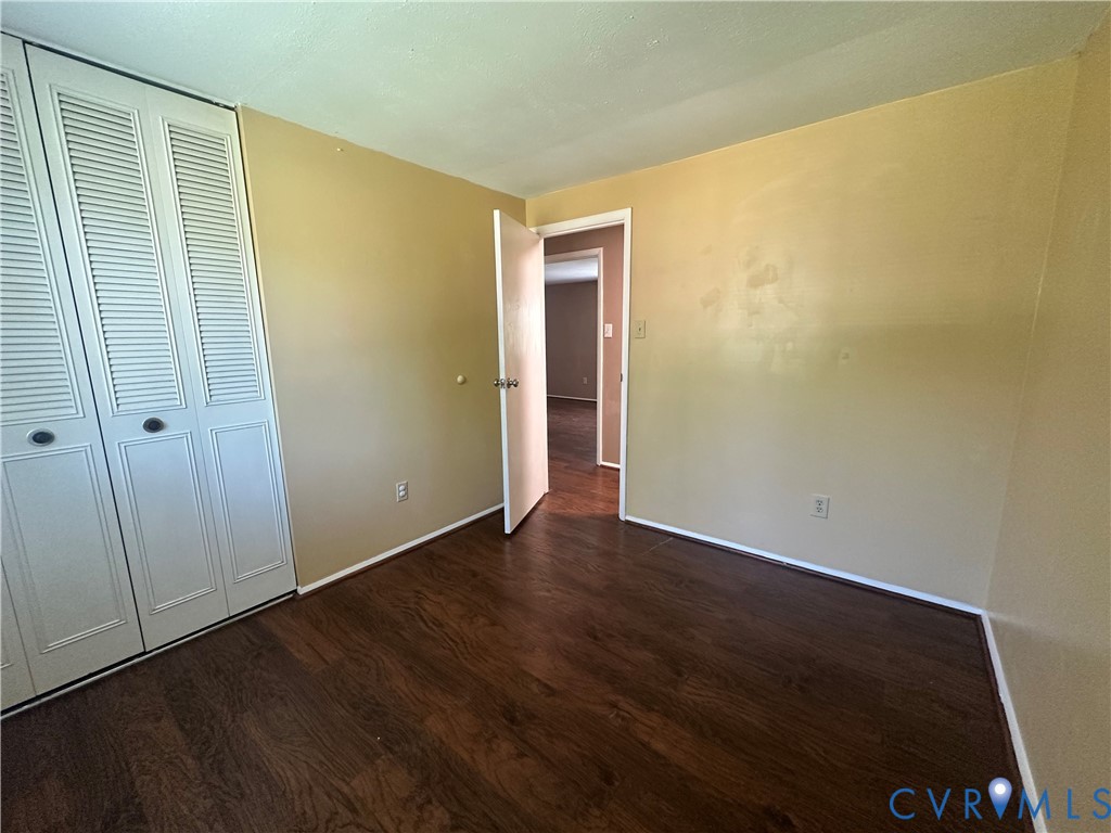 9319 Coleson Road Glen Allen, VA 23060 - Photo 18 of 39 a view of an empty room with wooden floor and a window
